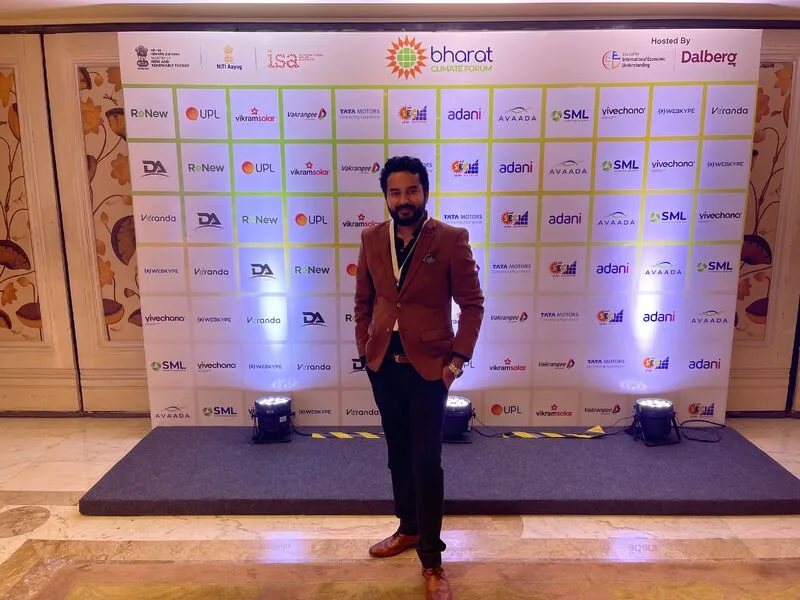 An attendee at the Bharat Climate Forum partner backdrop.
