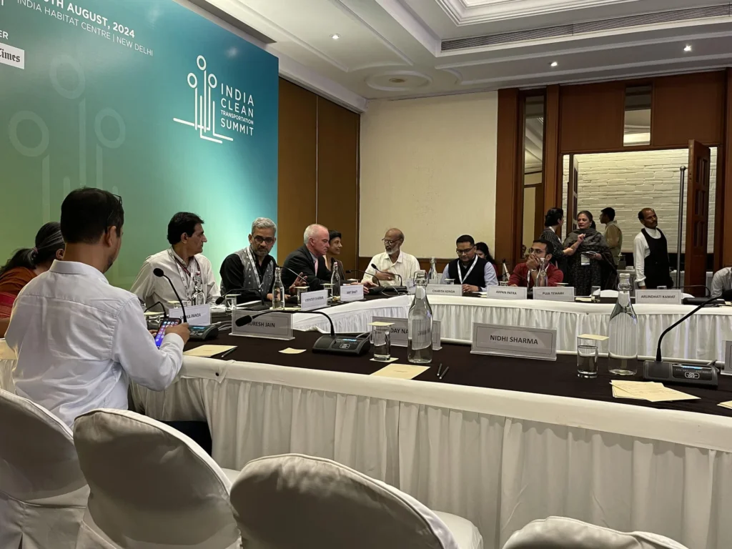 Participants seated around a conference table during the transport summit.