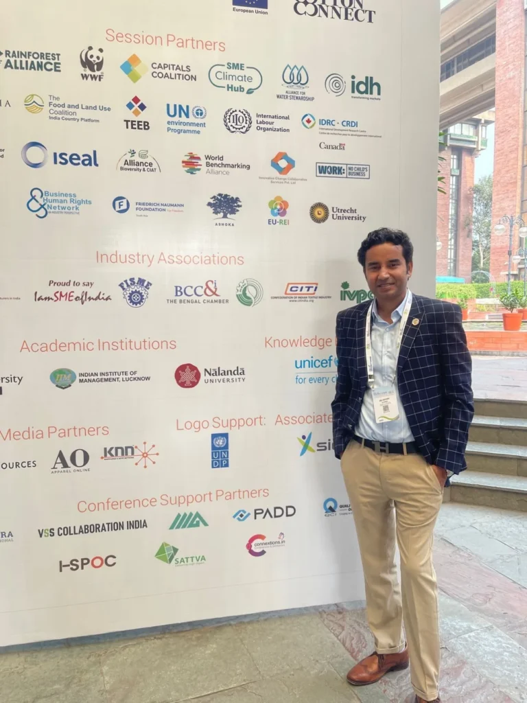 An attendee beside the conference partner display.