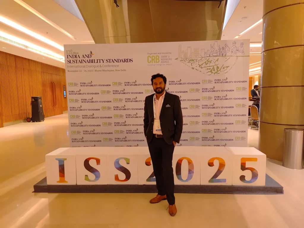An attendee beside the ISS 2025 display and conference backdrop.