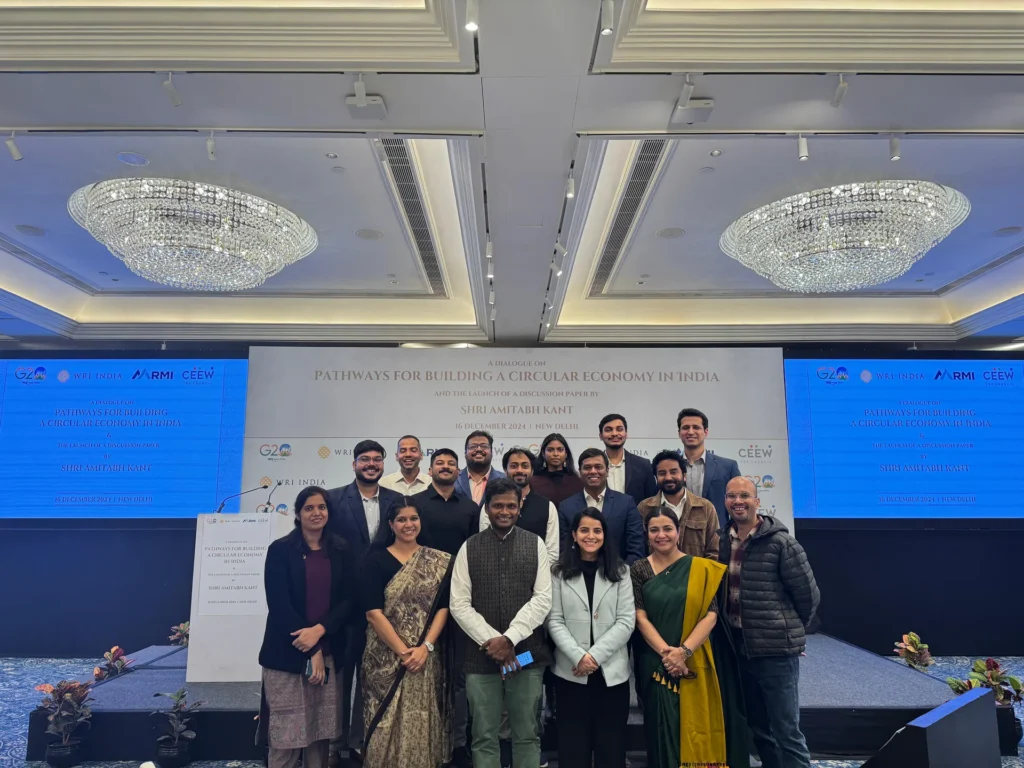 Participants gathered on stage beneath the circular economy event backdrop.