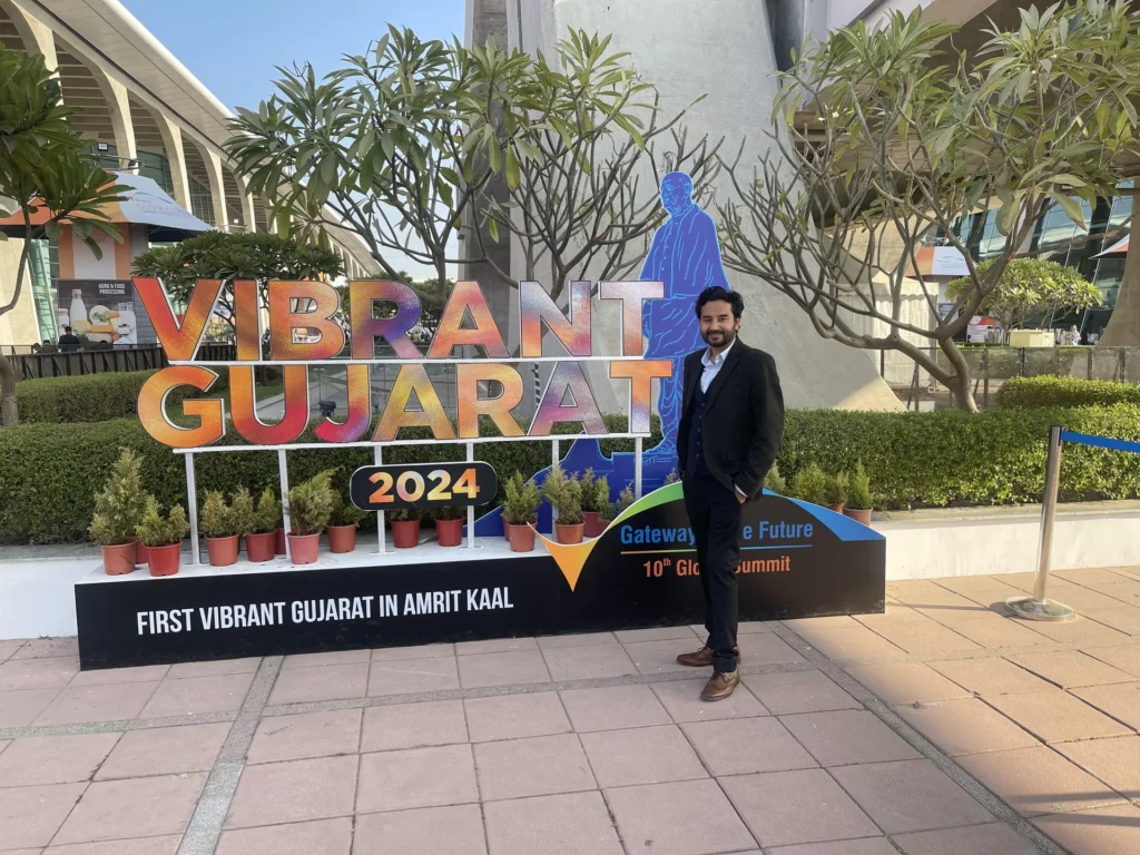 An attendee beside the Vibrant Gujarat 2024 summit installation.