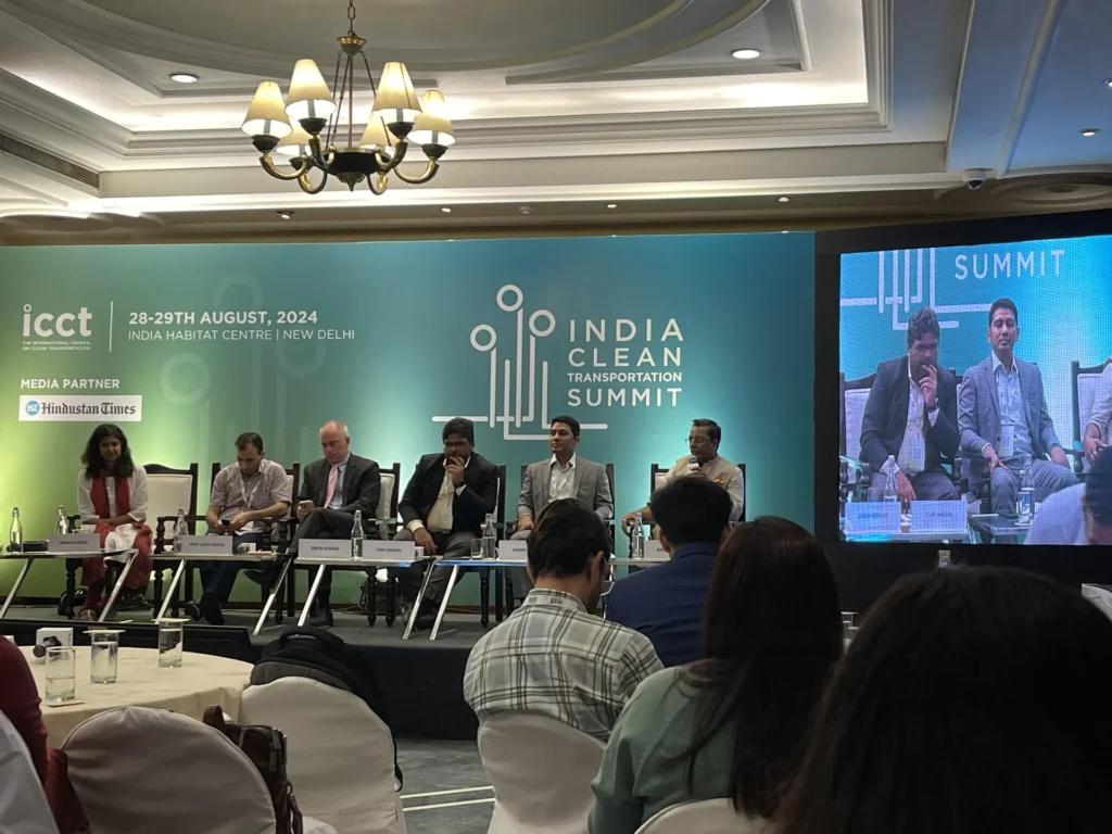 Panel members on stage beneath the India Clean Transport Summit screen.