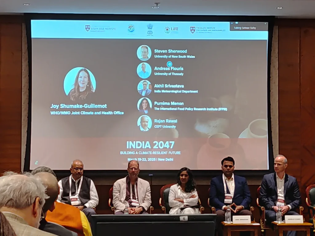 Panel members seated in front of the India 2047 session screen.