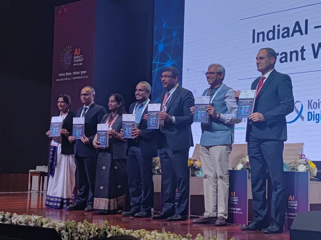 Participants holding publications during a presentation on stage.