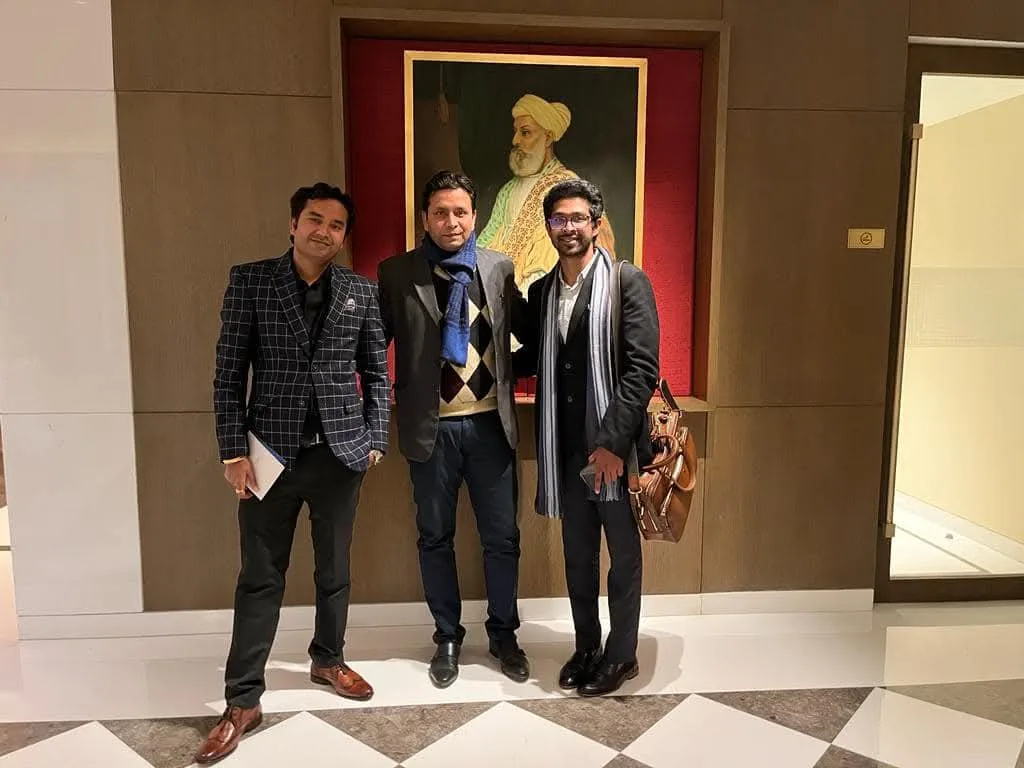 Three participants standing together inside the event venue.