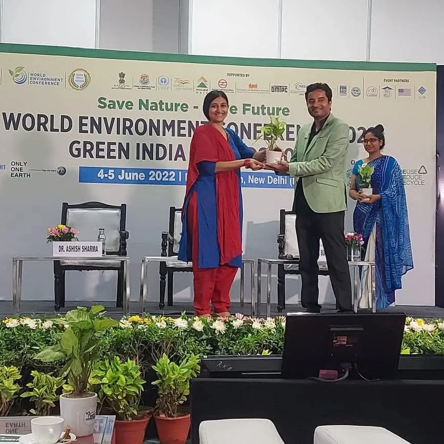 A participant receiving a certificate on the conference stage.