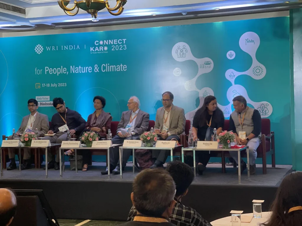 Panel members seated beneath the Connect Karo 2023 screen.