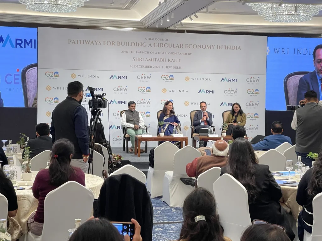 A panel discussion on the circular economy with the audience in the foreground.