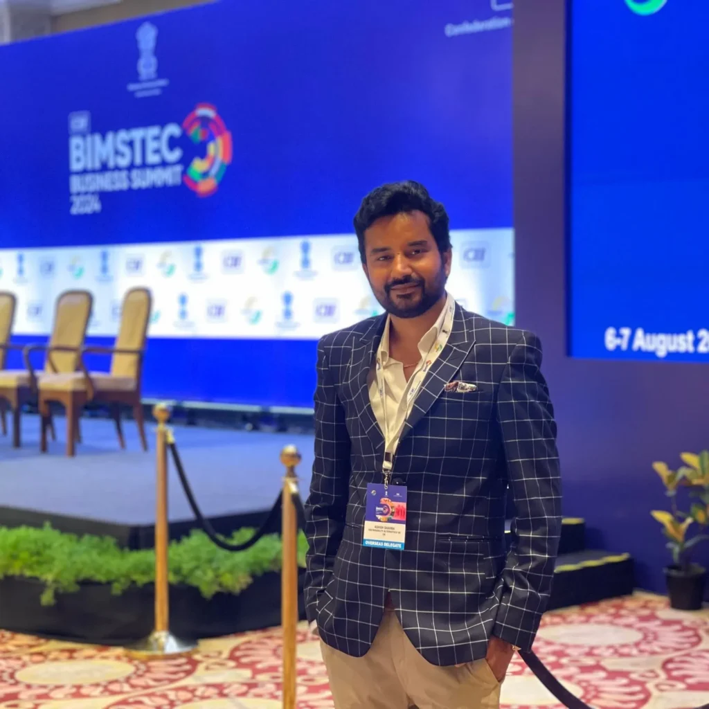 An attendee in front of the BIMSTEC Business Summit screen.
