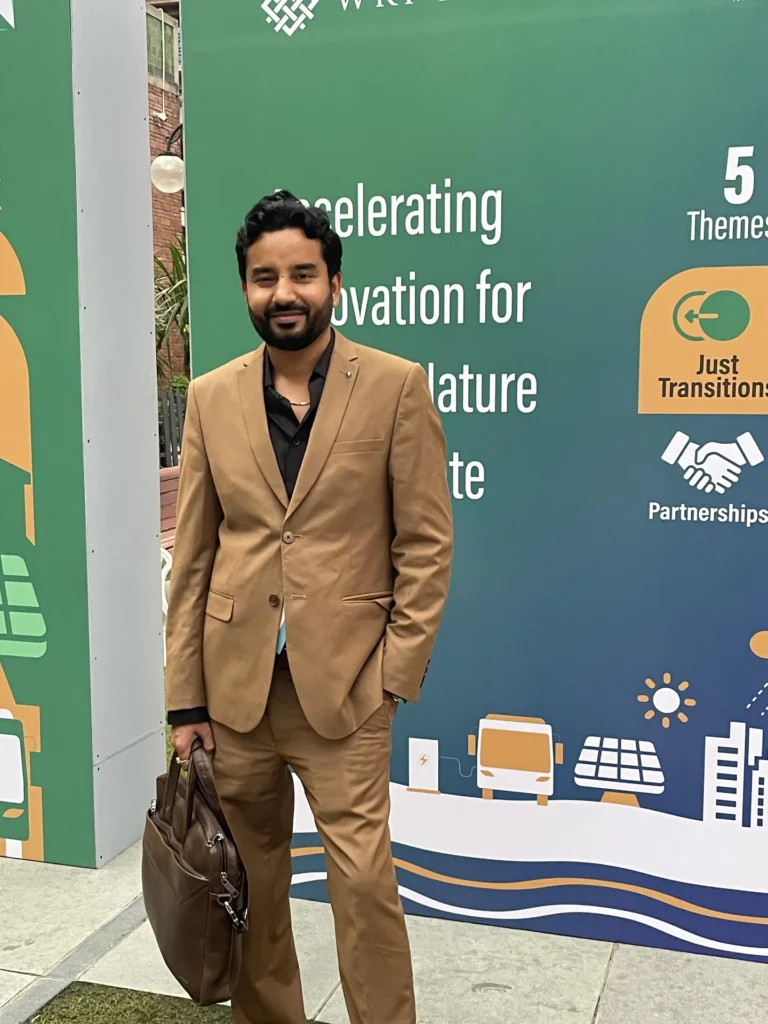 An attendee beside the Connect Karo exhibition display.