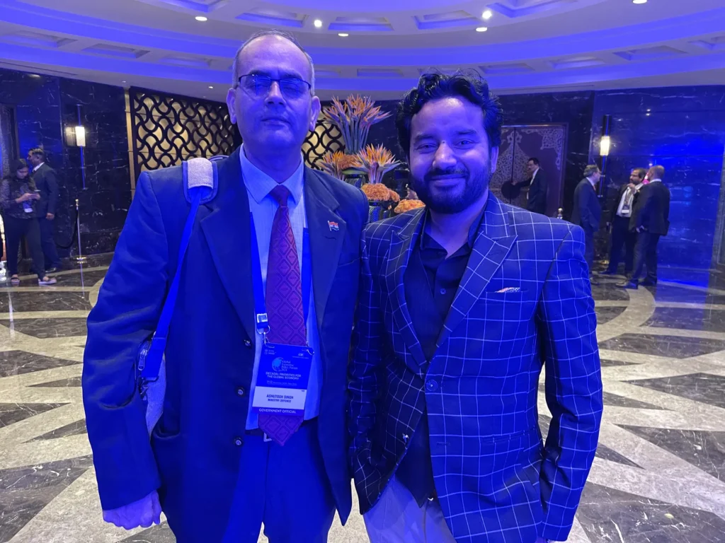 Two delegates standing together in the conference venue.