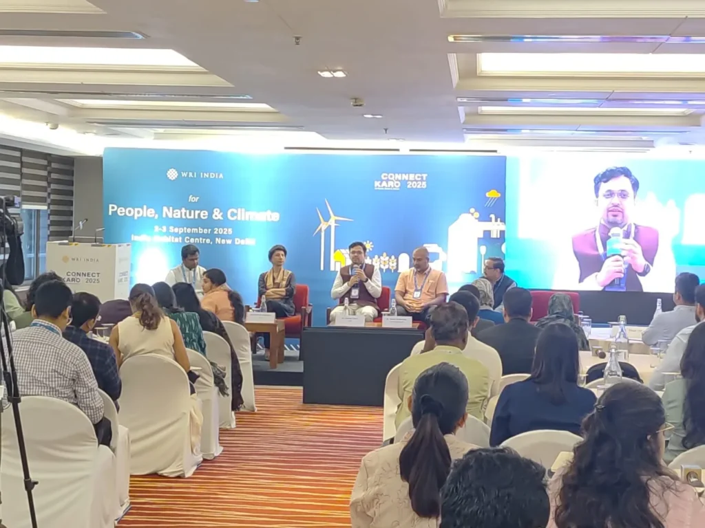 A panel discussion beneath the Connect Karo 2025 screen.