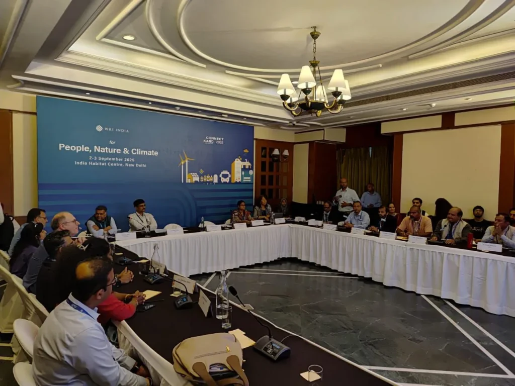Participants seated around a U-shaped conference table.