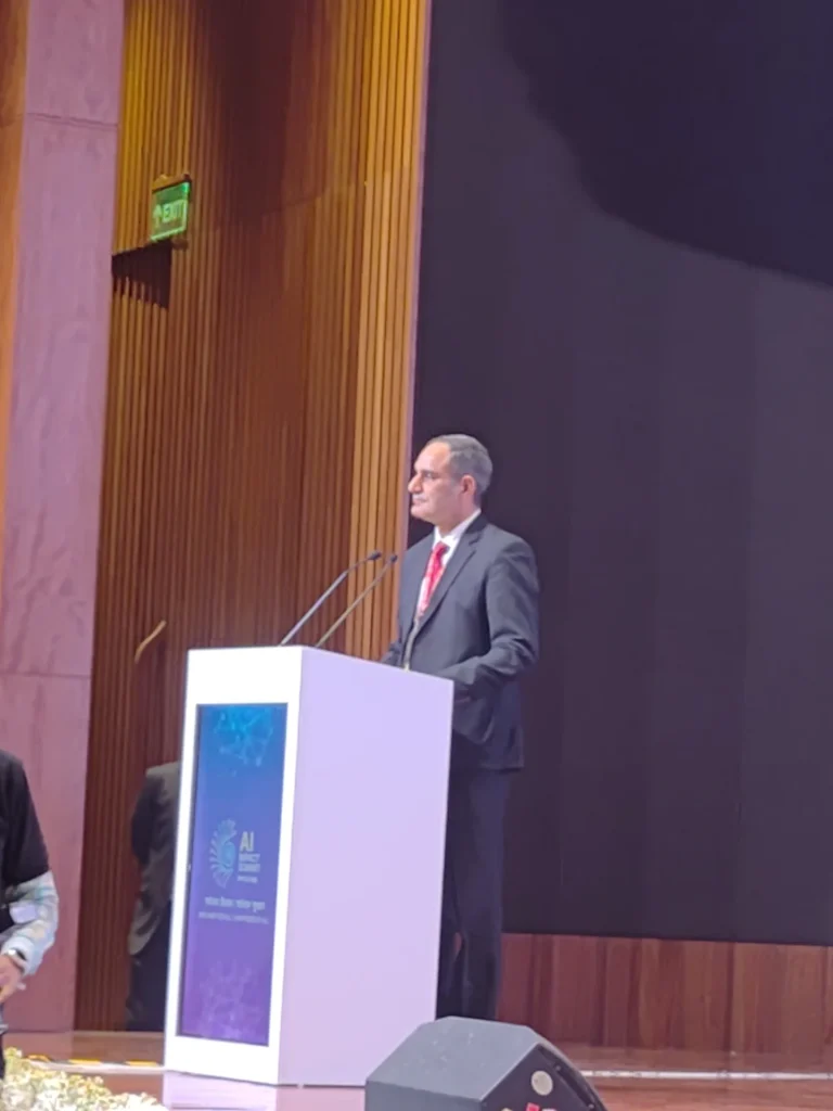 A speaker addressing the summit audience from a lectern.