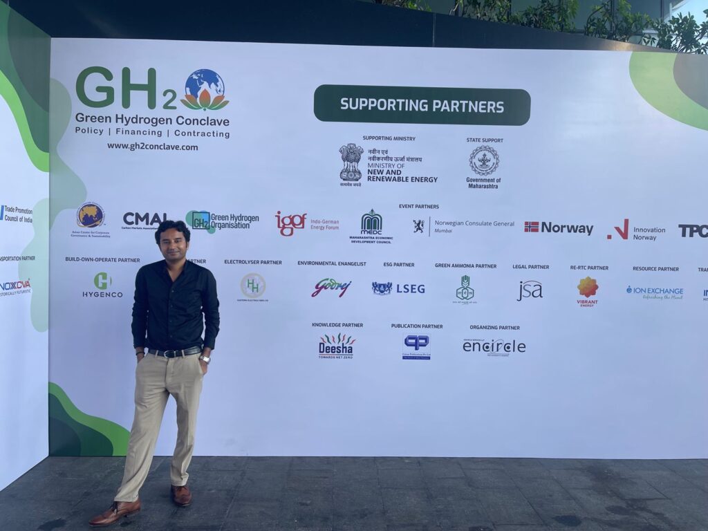 Dr. Ashish Sharma beside the Green Hydrogen Conclave event backdrop in Mumbai.