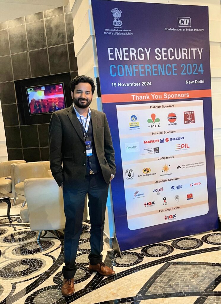 Dr. Ashish Sharma beside the CII Energy Security Conference 2024 banner
